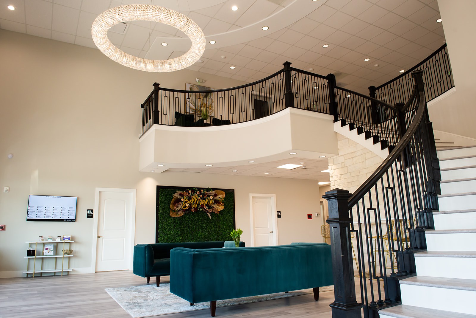 Bellevana two-story lobby with crystal chandelier and teal sofas