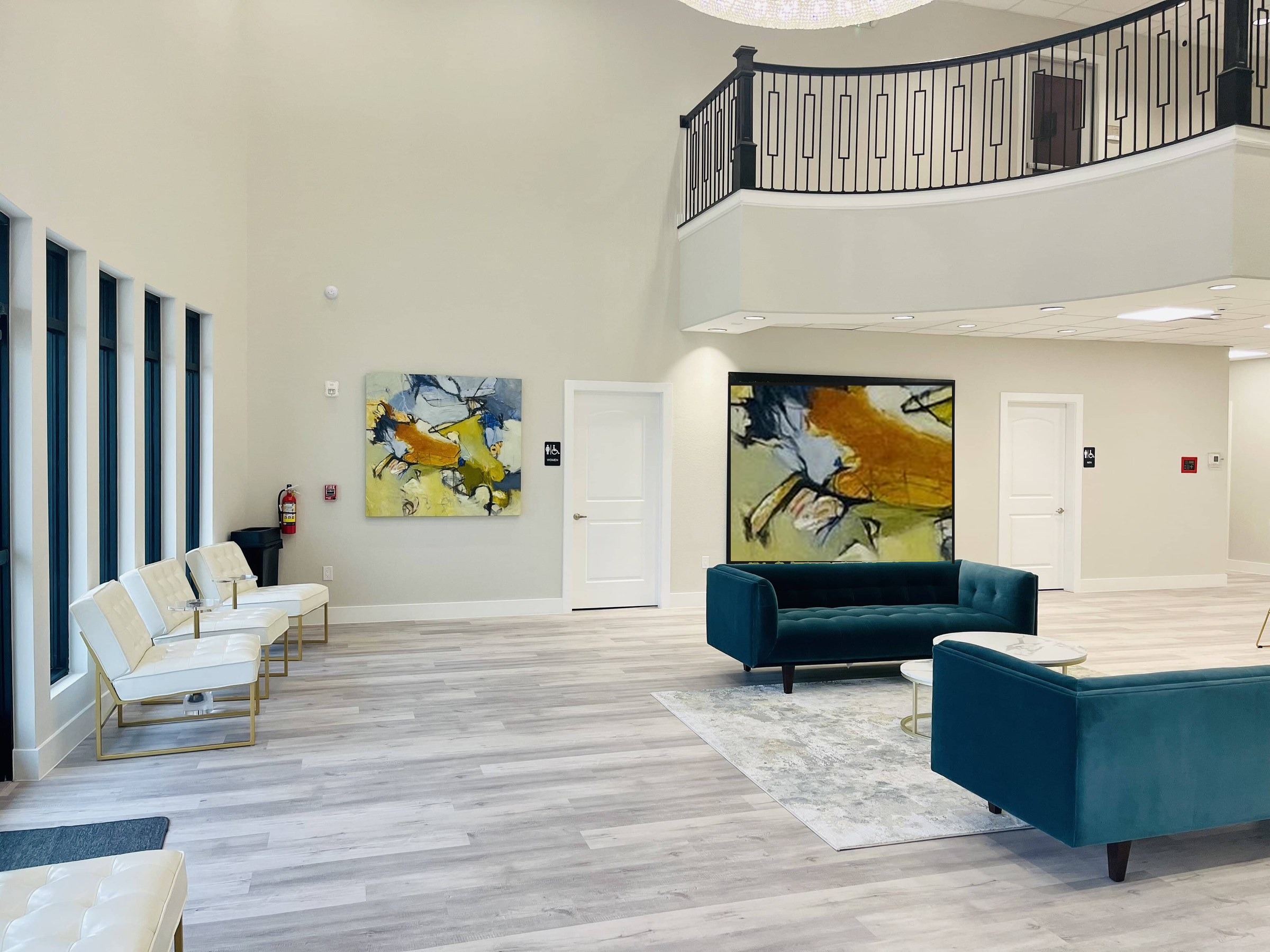 Bellevana lobby with teal seating and abstract wall art